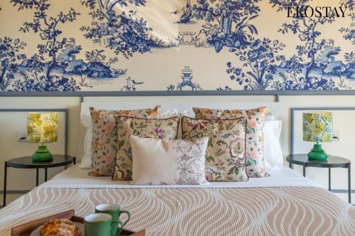 a bedroom with a bed with blue and white wallpaper at EKOSTAY - Amanta Green 8BHK in Karjat