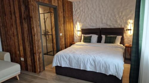 a bedroom with a large bed and a mirror at Rădăcini in Câmpulung Moldovenesc