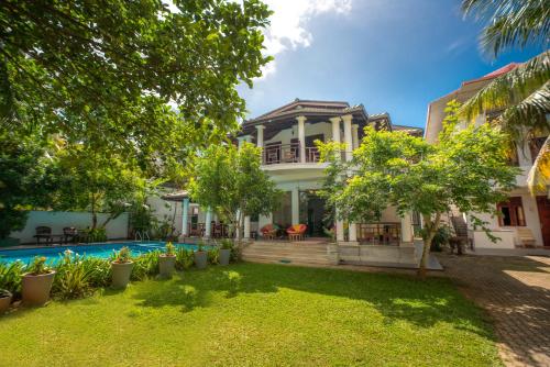 an exterior view of a house with a swimming pool at The Calm Of8 in Unawatuna