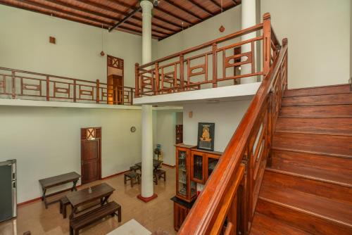 a large room with wooden stairs and a stair case at The Calm Of8 in Unawatuna