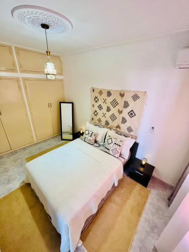 a bedroom with a large bed in a room at Apartment with AC and a nice private terrace Appartement CLIMATISÉ avec une jolie terrasse privée in Marrakech
