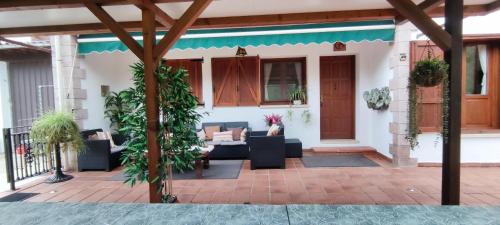 a house with a patio with a couch at Apartamento Rural Juana in Alles