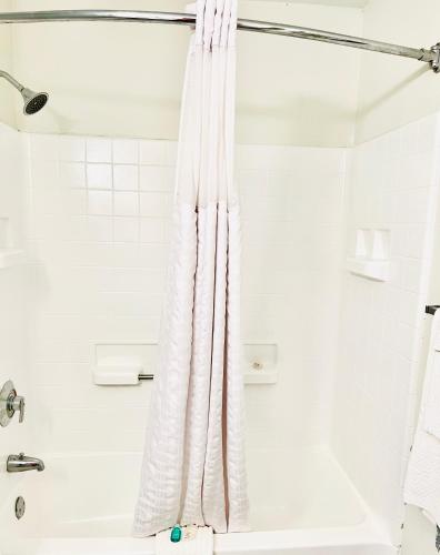 a shower curtain in a bathroom with a tub at MainStay Suites Little Rock West Near Medical Centers in Little Rock