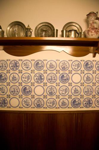 a shelf with blue and white plates on it at Gasthaus Merkel Hotel in Bad Berneck im Fichtelgebirge
