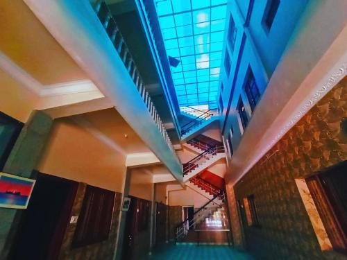 a hallway with a glass ceiling in a building at Hotel Hill Town Coorg in Madikeri