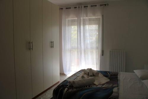 a person laying on a bed in a bedroom with a window at Belvedere da Madia in Monopoli