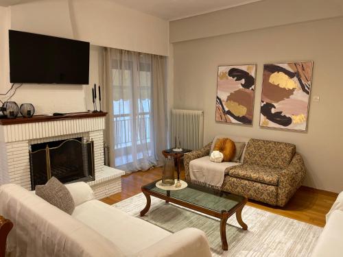 a living room with a couch and a fireplace at ID Home in Ioannina