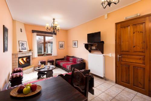 a living room with a couch and a table at Amygdalies Apartments with Fireplace in Karpenision
