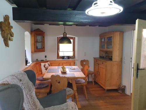 a kitchen and dining room with a table and chairs at Haus Bachrauschen in Kirchanschöring