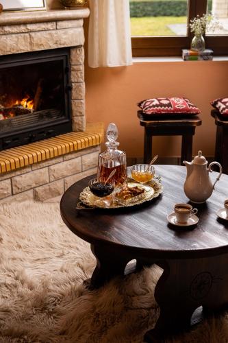 a coffee table in a living room with a fireplace at Amygdalies Apartments with Fireplace in Karpenision