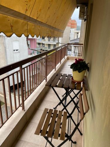 a balcony with a bench and a potted plant on it at ID Home in Ioannina