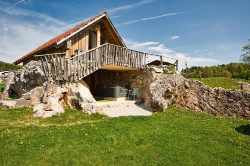 a house on top of a large rock at Farm Stay Ana in Višnja Gora