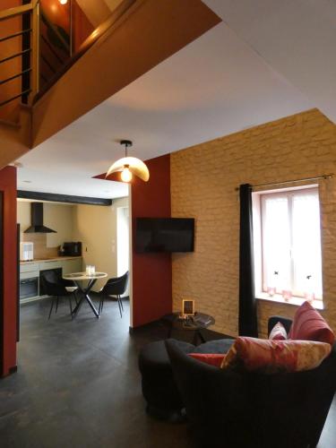 un salon avec un canapé et une table dans l'établissement Volute et Volupté - Une Spirale de Plaisirs, à Hiéville