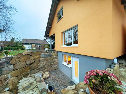 a house with a stone wall and a window at Carpe Diem in Altshausen