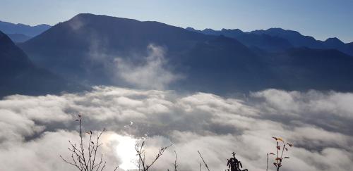 a view of a mountain with clouds in front of it at Ferienhaus TraunseeStrand in Ebensee