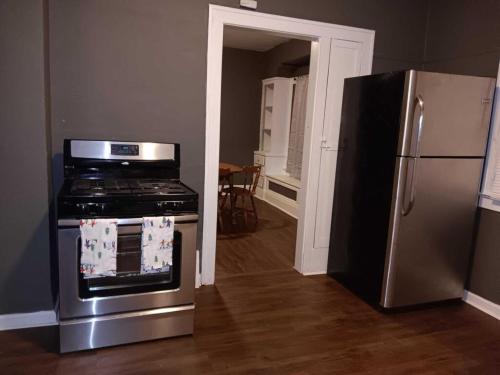 a kitchen with a stove and a refrigerator at Experience a home near Cleveland Clinic & parks in Cleveland
