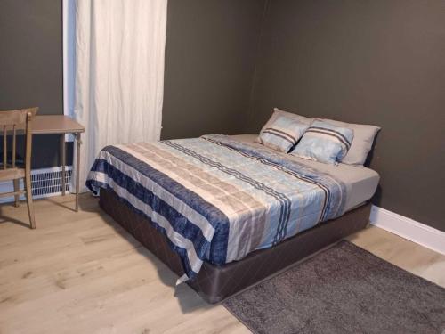 a bedroom with a bed with a blanket on it at Experience a home near Cleveland Clinic & parks in Cleveland