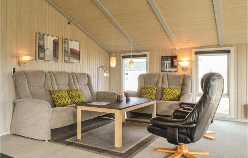 a living room with a couch and a table at Holiday Home Dortheasvej Hvide Sande Vi in Bjerregård