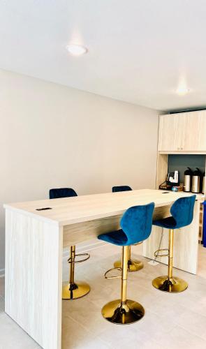 an office with a wooden desk with blue chairs at MainStay Suites Little Rock West Near Medical Centers in Little Rock