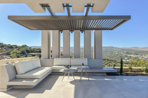 a living room with a couch and a table at Youphoria Sea View Villas in Kissamos