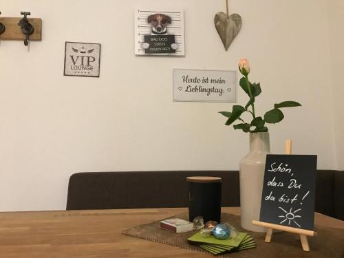 a table with a vase with a flower in it at Appartementhaus Angelika in Nittenau