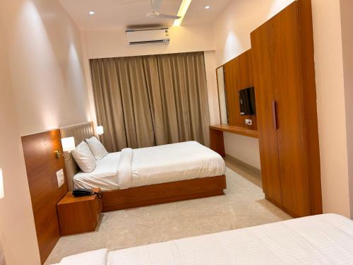 Postel nebo postele na pokoji v ubytování Hotel Neem Heritage