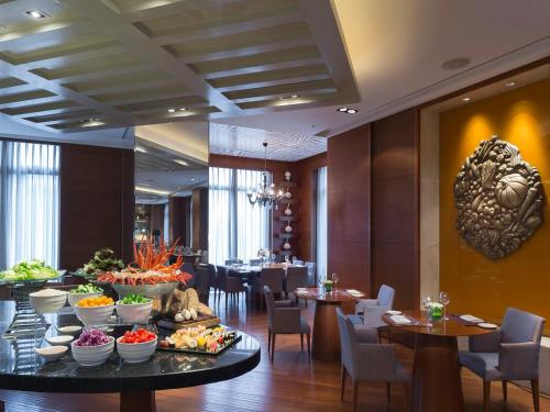a restaurant with a buffet of food on a table at Marco Polo Wuhan in Wuhan