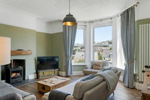 a living room with a couch and a tv at Spacious House & Garden in Ilfracombe in Ilfracombe