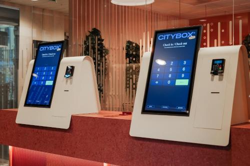 two displays of a cell phone on a counter at Citybox Bergen City in Bergen
