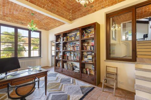 a room with a desk and book shelves at Villa Teresa - Enticing villa with pool and views! in Gabiano
