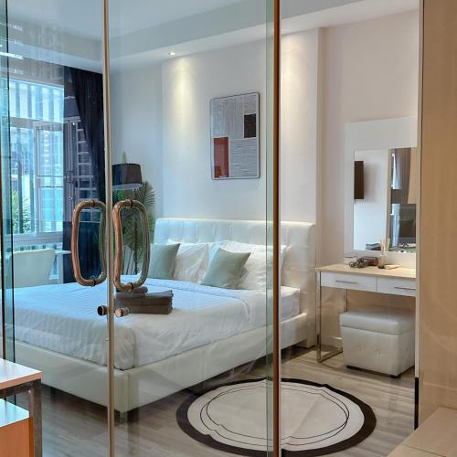 a bedroom with a bed and a glass door at Stylish room Near Central Fest in Chiang Mai