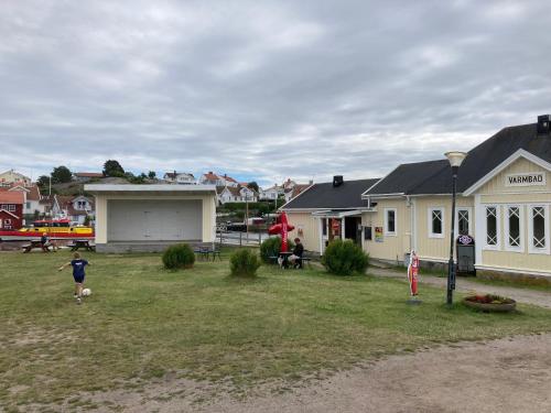 a child playing soccer in the yard of a house at Badholmens Vandrarhem in Fjällbacka