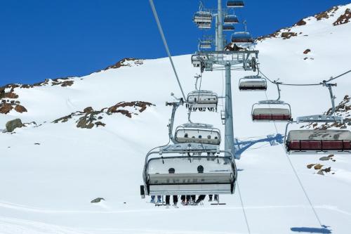 a ski lift with people on it in the snow at La Flèche 2 - Chalet Standing - Jacuzzi Privatif in Besse-et-Saint-Anastaise