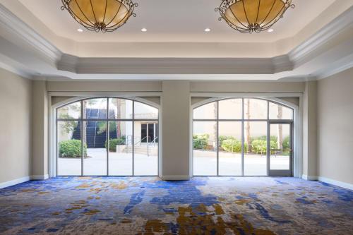 an empty room with large windows and large doors at JW Marriott Las Vegas Resort & Spa in Las Vegas