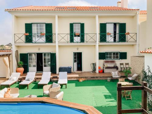 a villa with a swimming pool and a house at In my house Baleal in Ferrel