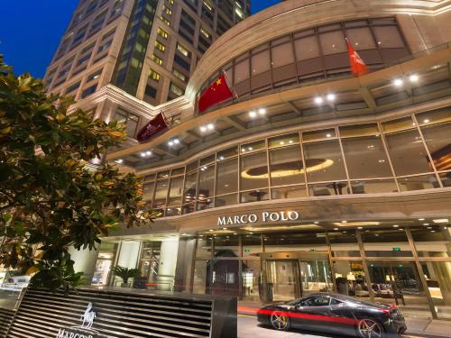 a car parked in front of a marco polo building at Marco Polo Wuhan in Wuhan