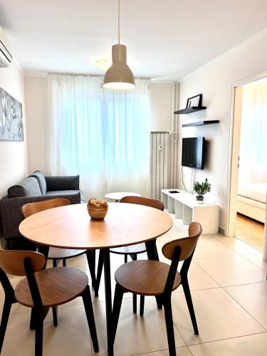 a living room with a table and chairs at Apartment Family in Zagreb