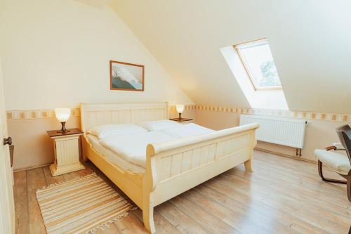 a bedroom with a bed and two lamps and a window at Penzion Bene in Chotěboř