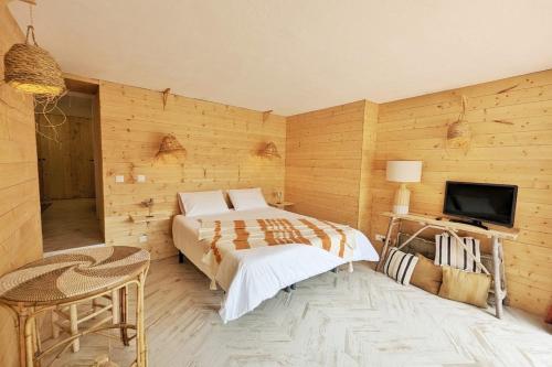 a bedroom with a bed and a television in it at L'Évasion Naturelle N1 des Villages des Français in Argelès-sur-Mer