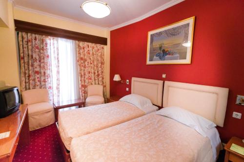 Ένα ή περισσότερα κρεβάτια σε δωμάτιο στο Grand Hotel