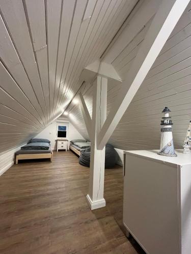 a room with two beds and a white ceiling at FeWo Wald & Düne in Karlshagen