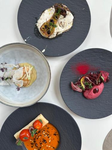a group of plates of food on a table at Zenitude Hotel la Valadière, an Ascend Collection Hotel in Montpellier