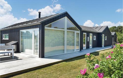 a rendering of a black house with a deck at Holiday Home Ebeltoft With A Fireplace 9 in Ebeltoft