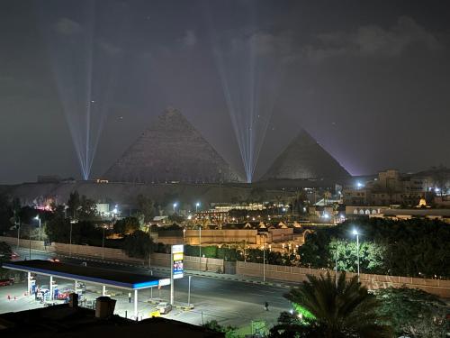 a view of the pyramids of giza at night at Unique Pyramids Boutique INN in Cairo