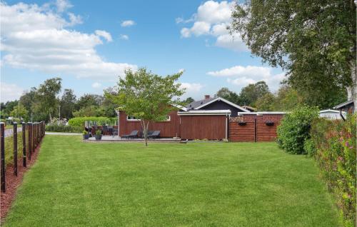 a yard with a fence and a house at Pet Friendly Home In Grenaa With Wifi in Grenå