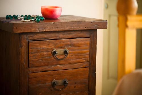 a wooden dresser with an apple on top of it at Santanna Suites in Patmos
