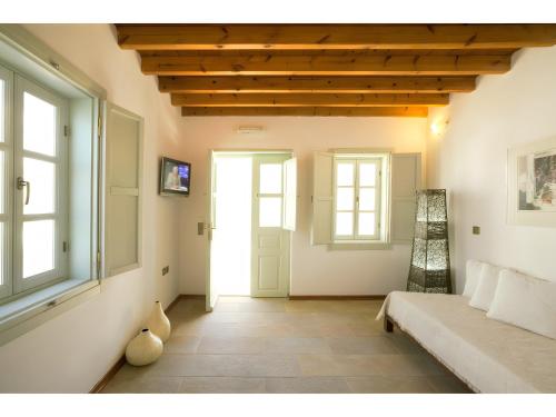 a living room with a bed and a window at Santanna Suites in Patmos