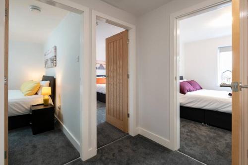 a room with two beds and a door to a bedroom at Brumby 3-Bed House by Brookland Stays Serviced Accommodation with WiFi in Brumby
