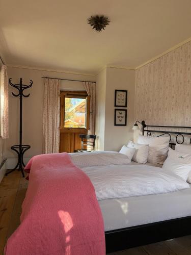 a bedroom with two beds with red blankets on them at Lohei - Historisches Zuhäusl in Unterwössen
