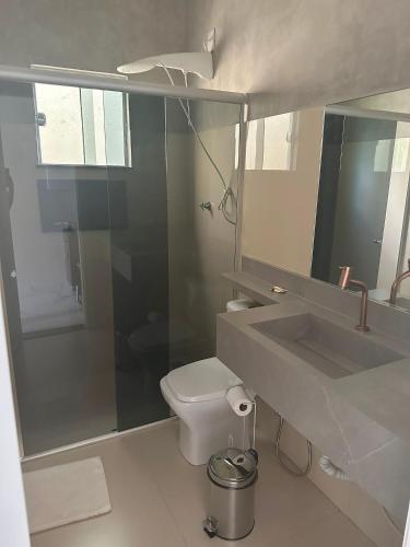 a bathroom with a sink and a toilet and a mirror at Villa'S Roraima in Boa Vista